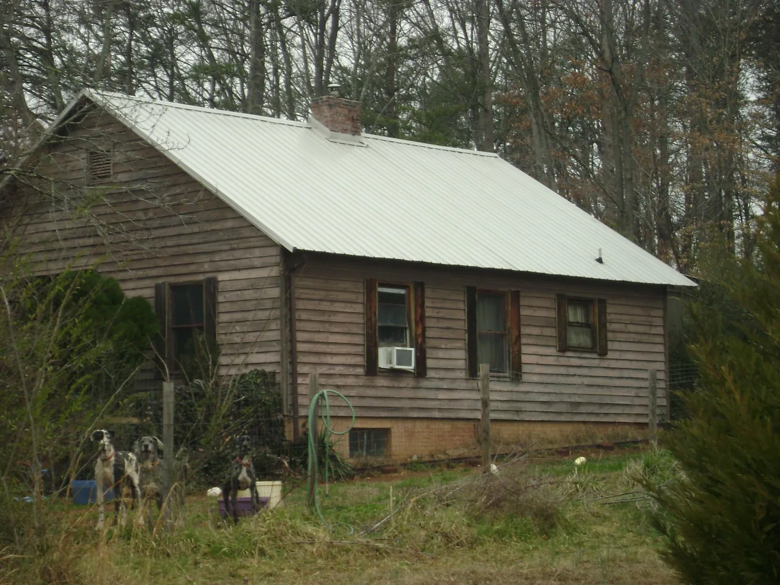 White metal roof on an old wood sided farmhouse, from a Metal Roof Installation job in Palmyra